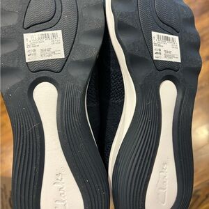 Blue Clarks slip on sneakers, size 10, never worn! Brand new. Very comfortable.